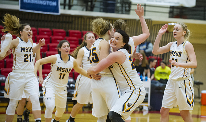 Janiel Olson (right) embraces Rylee Kane at the end of MSU Billings' win over Northwest Nazarene. Olson's 17 rebounds tied the GNAC Championships record.